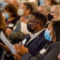 Attendees clapping during dedication